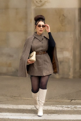a lady in a coffee brown cloak and vest